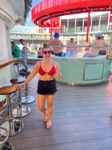 Guests in red celebrating Scarlet Night on Virgin Voyages cruise tips