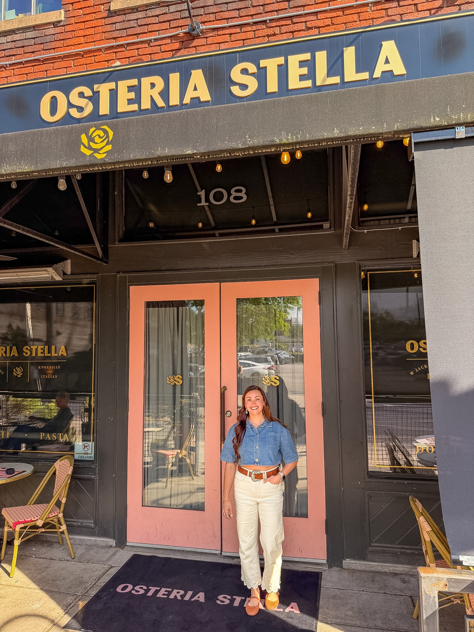 Osteria Stella Knoxville pink door entrance with gold lettering