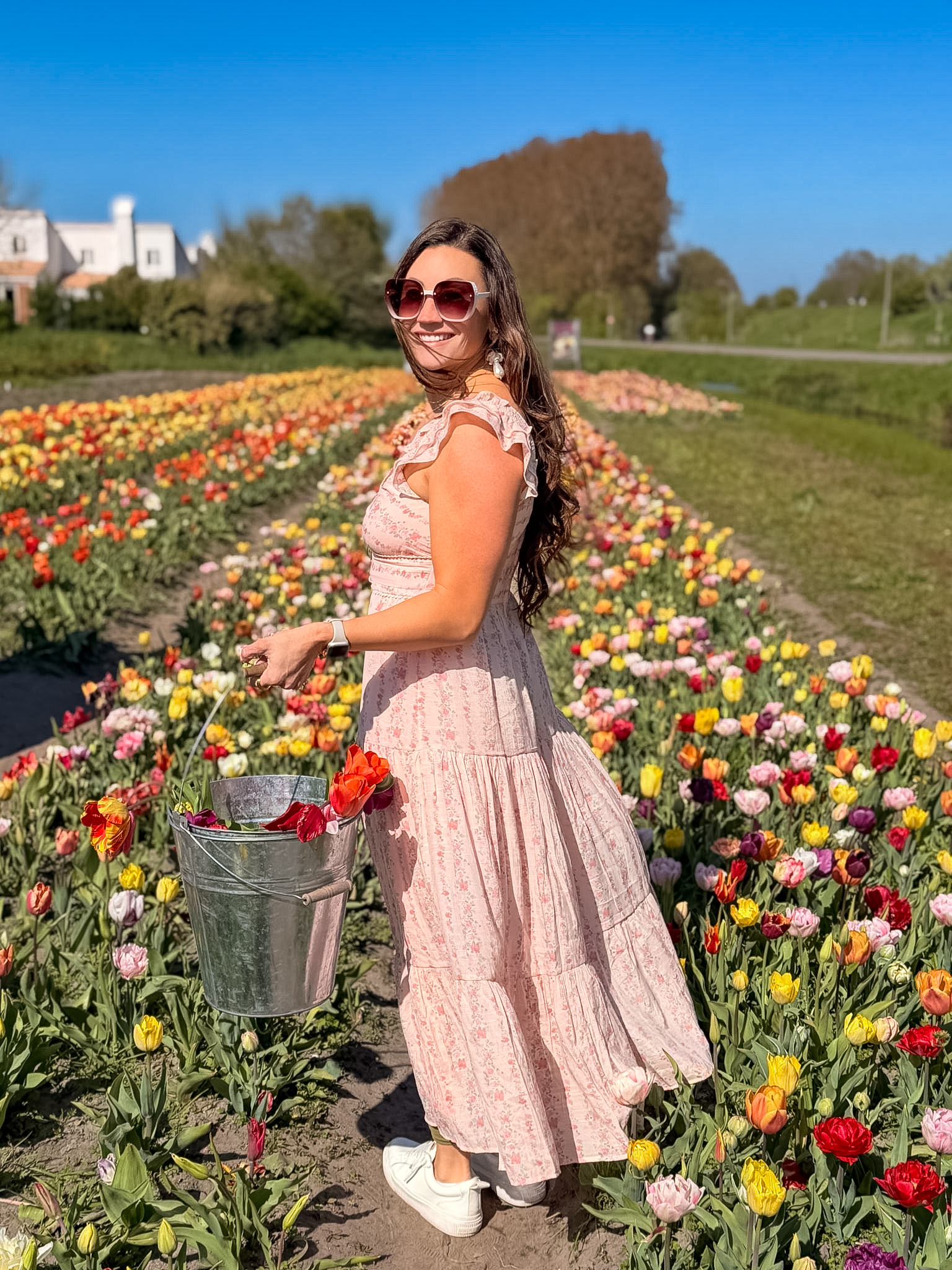 Light pink dress styled for what to wear in the tulip fields Netherlands during tulip season
