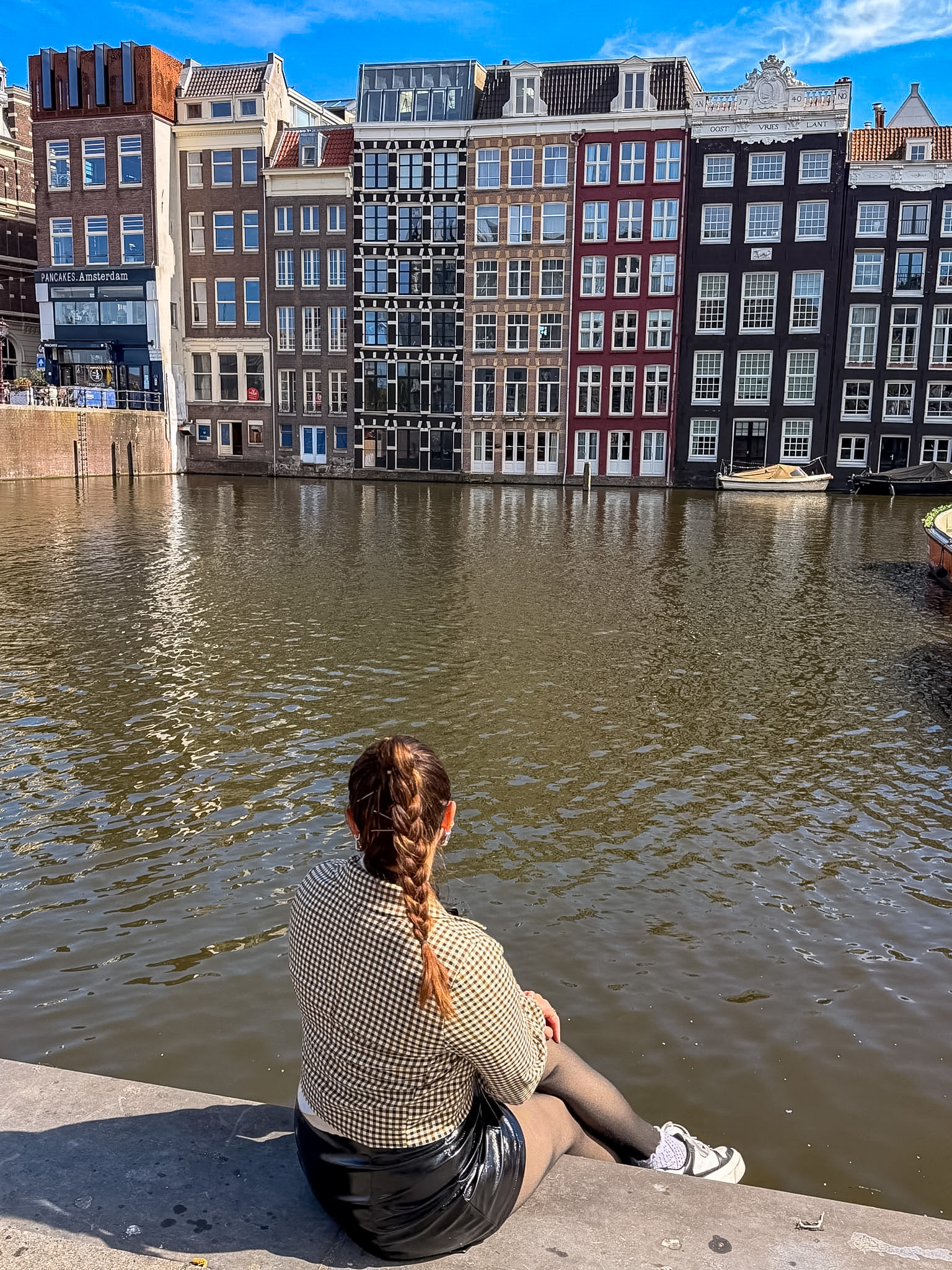 Sitting by a canal during our Amsterdam trip