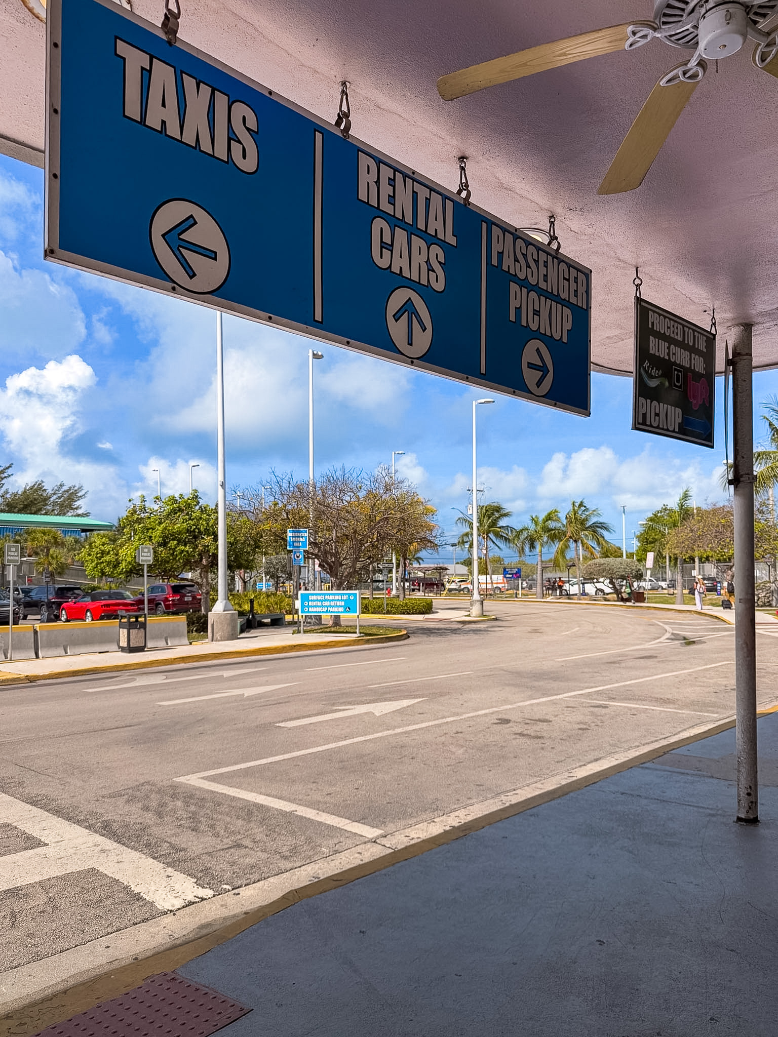 Key West airport rideshare pickup area near the blue curb