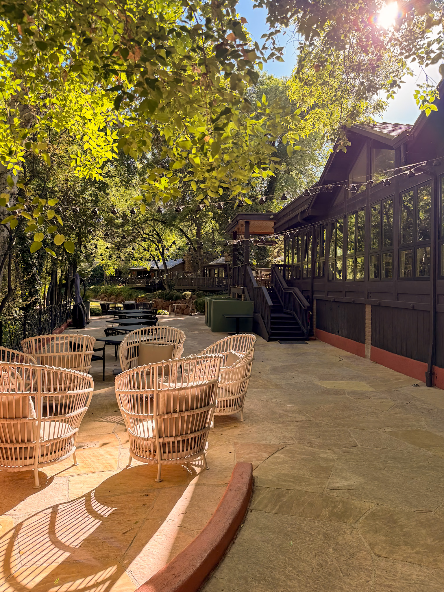 Cress on Oak Creek review showing an outdoor creekside table at L’Auberge de Sedona