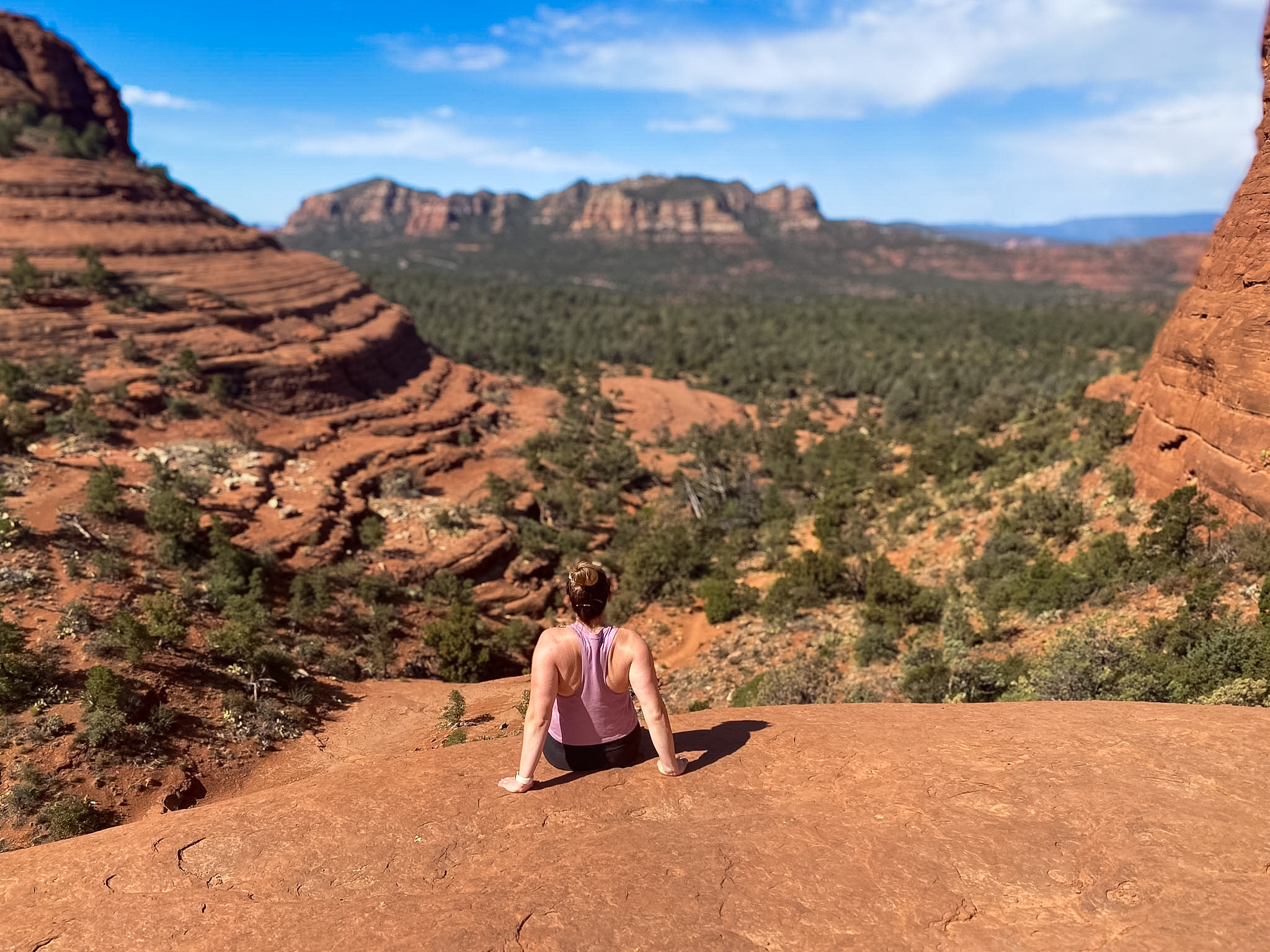 Pink Jeep driving across the red rocks during a 3 day Sedona itinerary