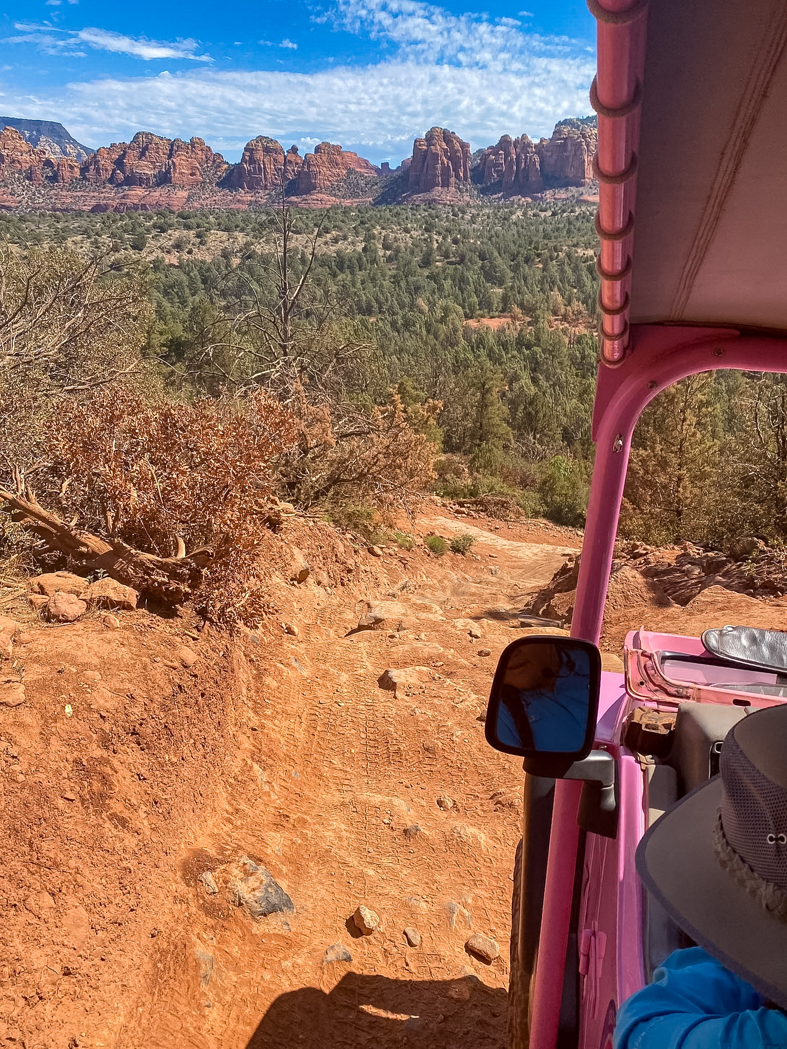 Pink Jeep driving across the red rocks during a 3 day Sedona itinerary