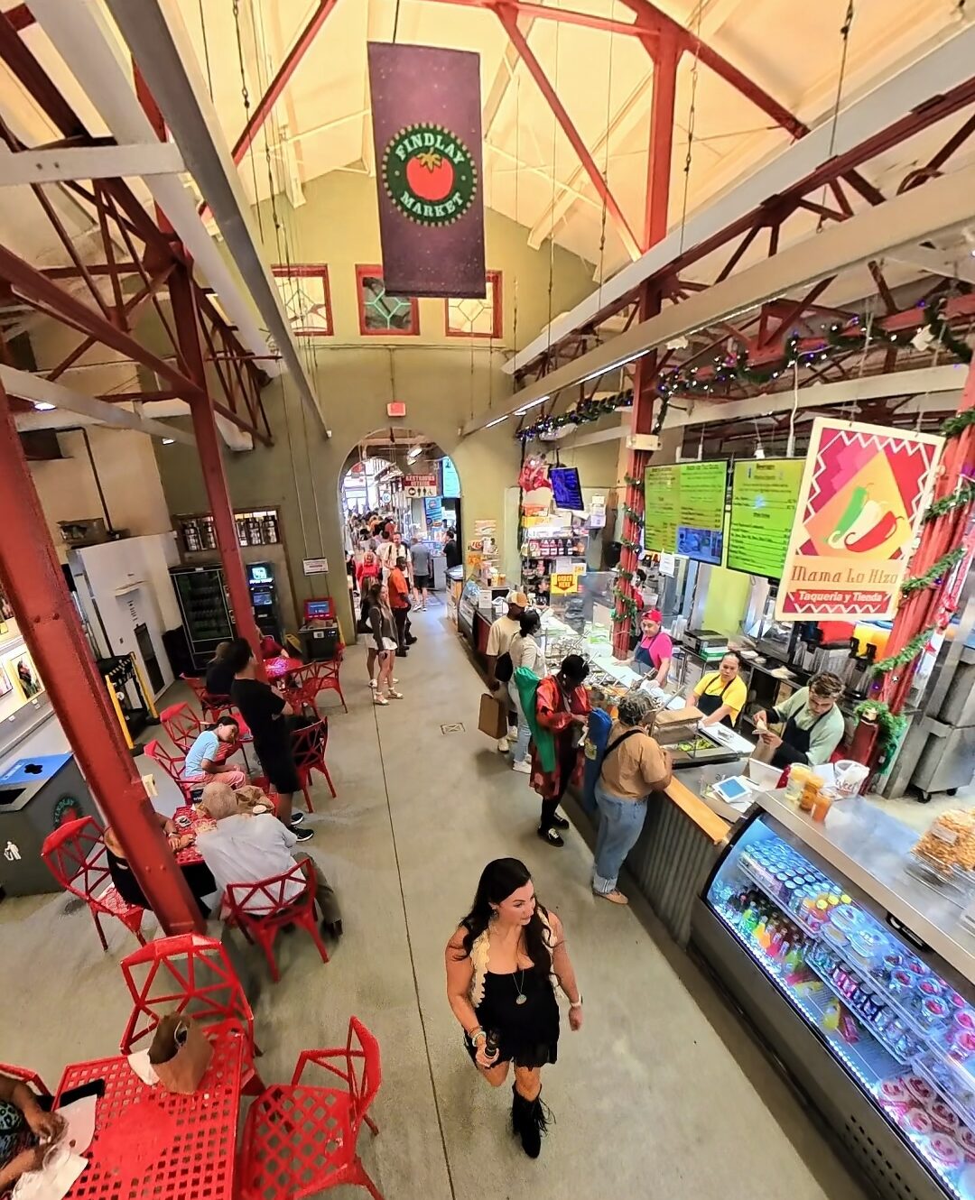 Best Places to Eat in Cincinnati featuring food vendors and shoppers inside Findlay Market