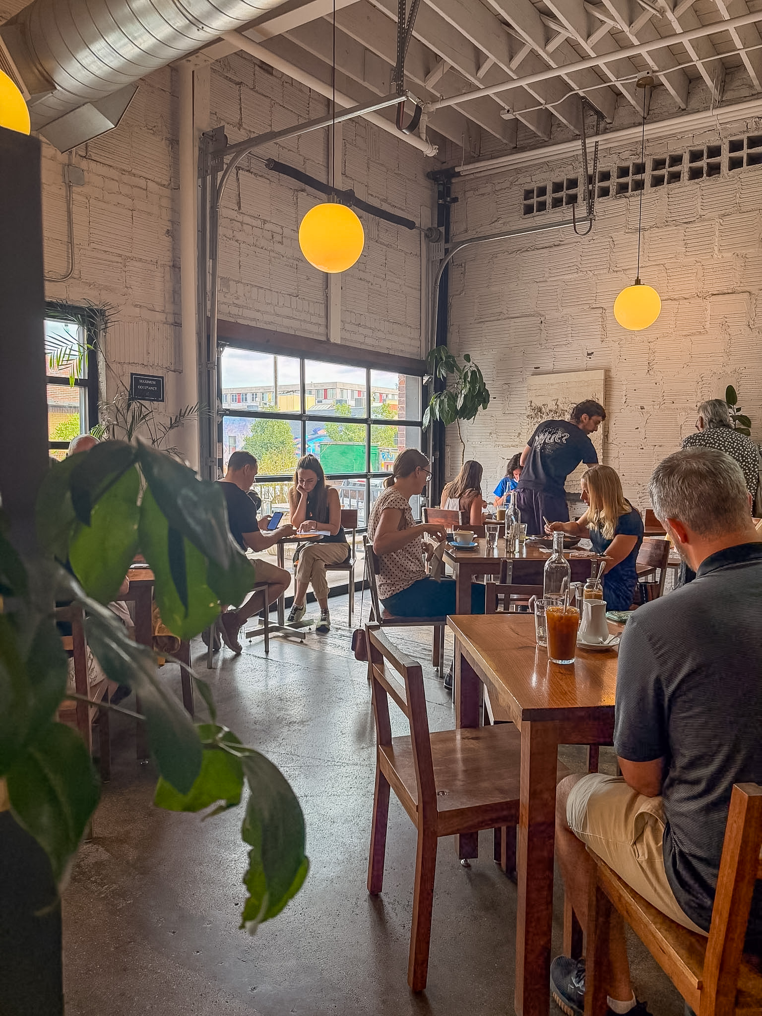 Stowaway Kitchen Denver brunch table with waffle, cornbread, and breakfast sandwich