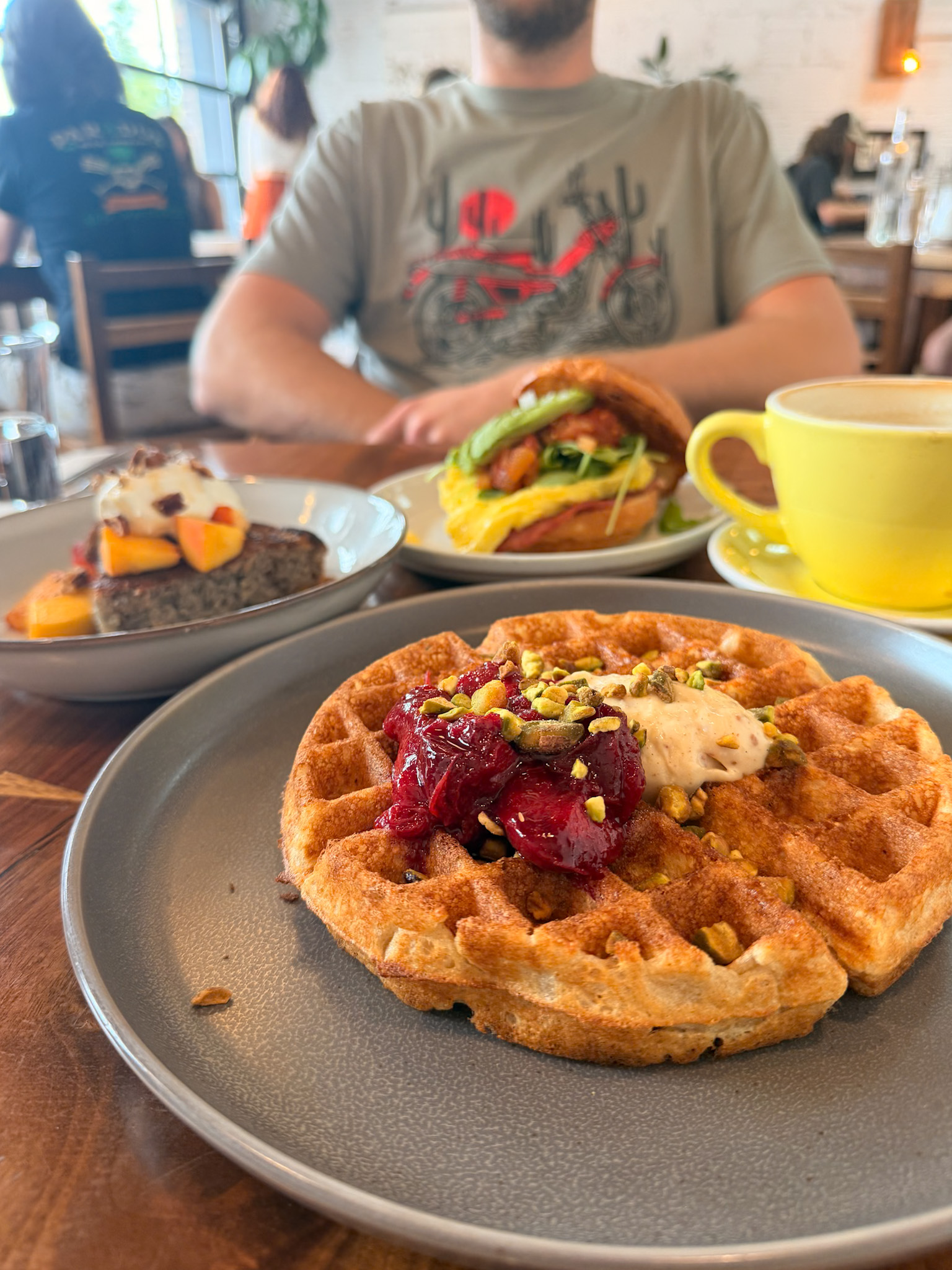 Stowaway Kitchen Denver sherry plum and Basque cheesecake waffle with pistachios and maple syrup