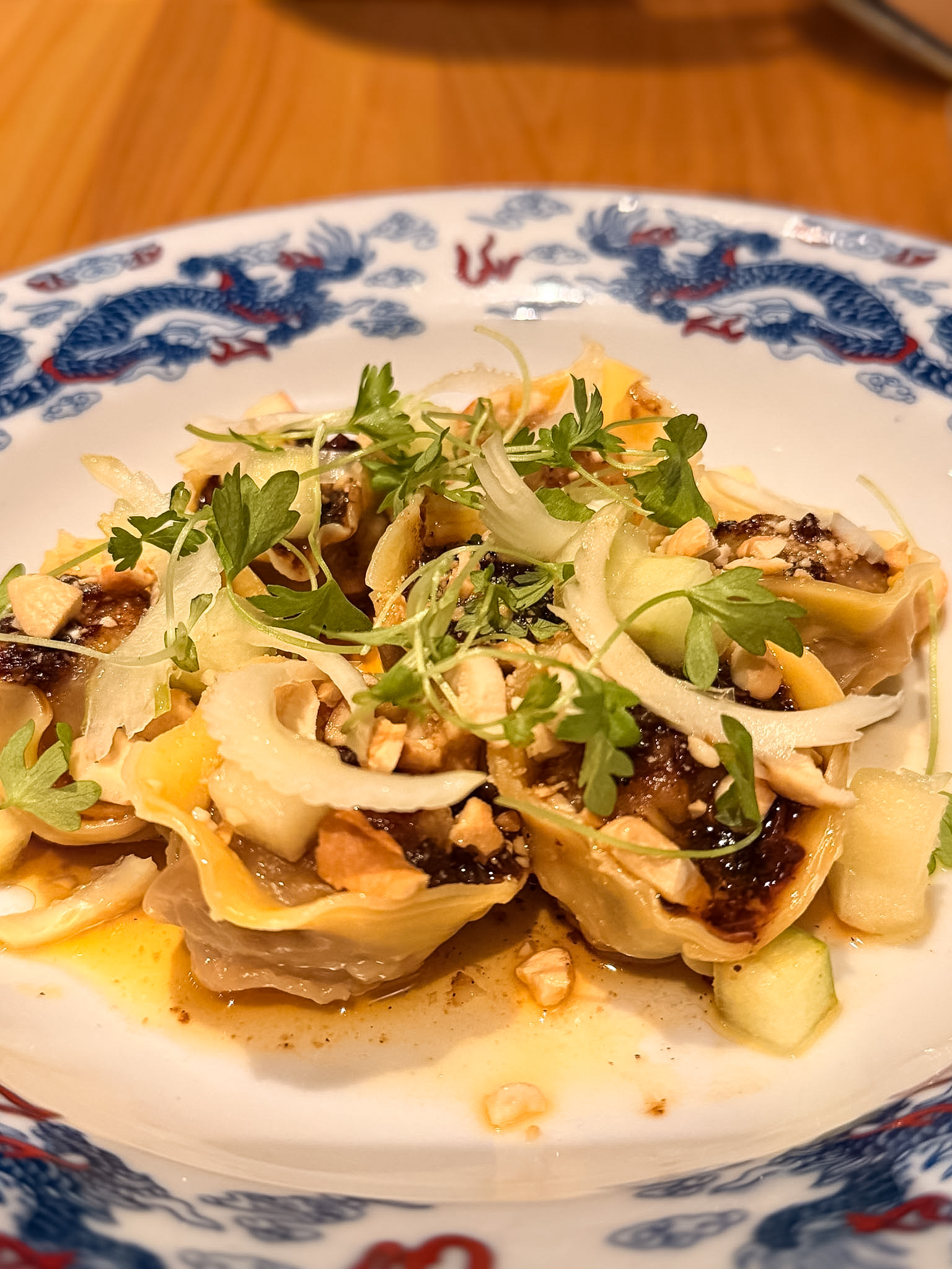 Hop Alley Denver beef and celery dumplings with chili crisp, apple, and cashew