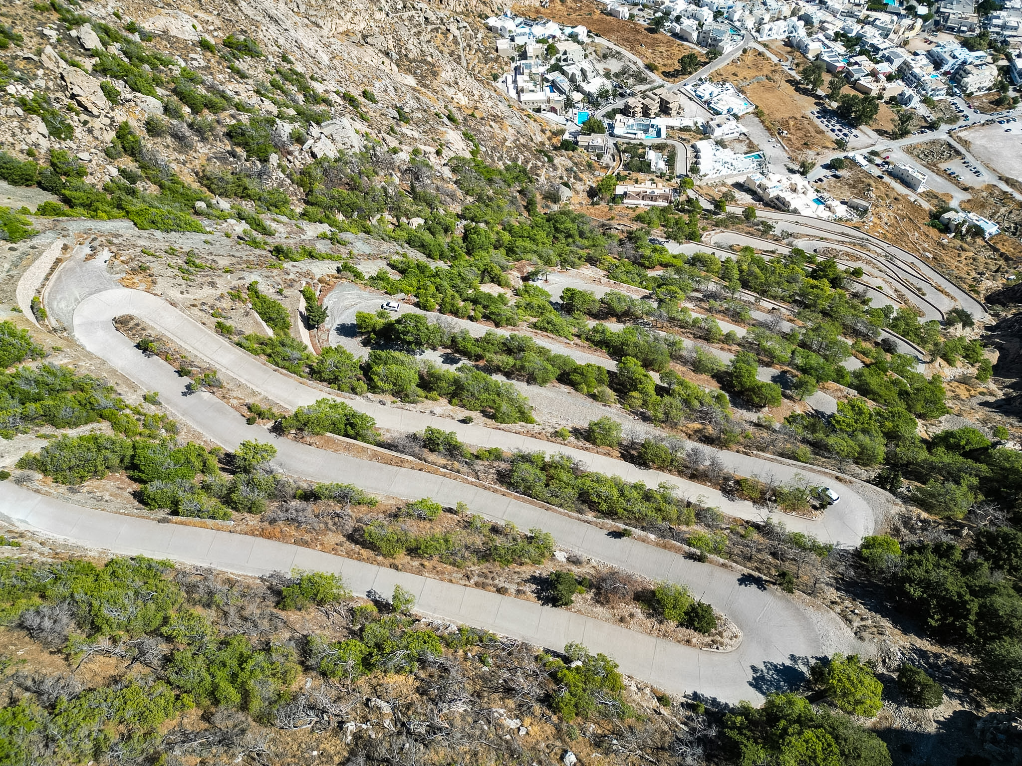 Winding mountain road with hairpin turns leading to Ancient Thera from Kamari