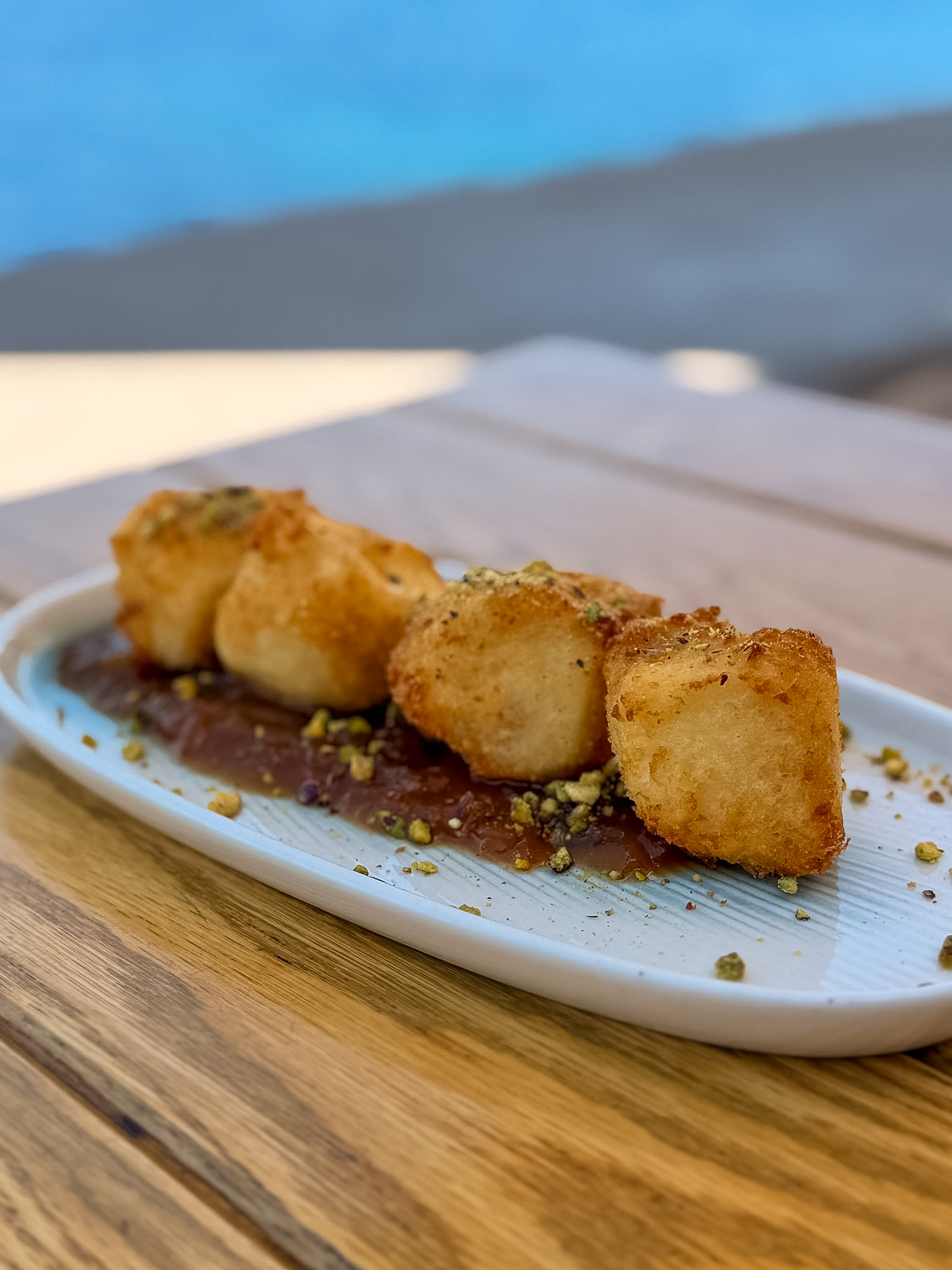 Sunset Restaurant Hydra review featuring crispy panko-crusted feta with prickly pear chutney and pistachios.