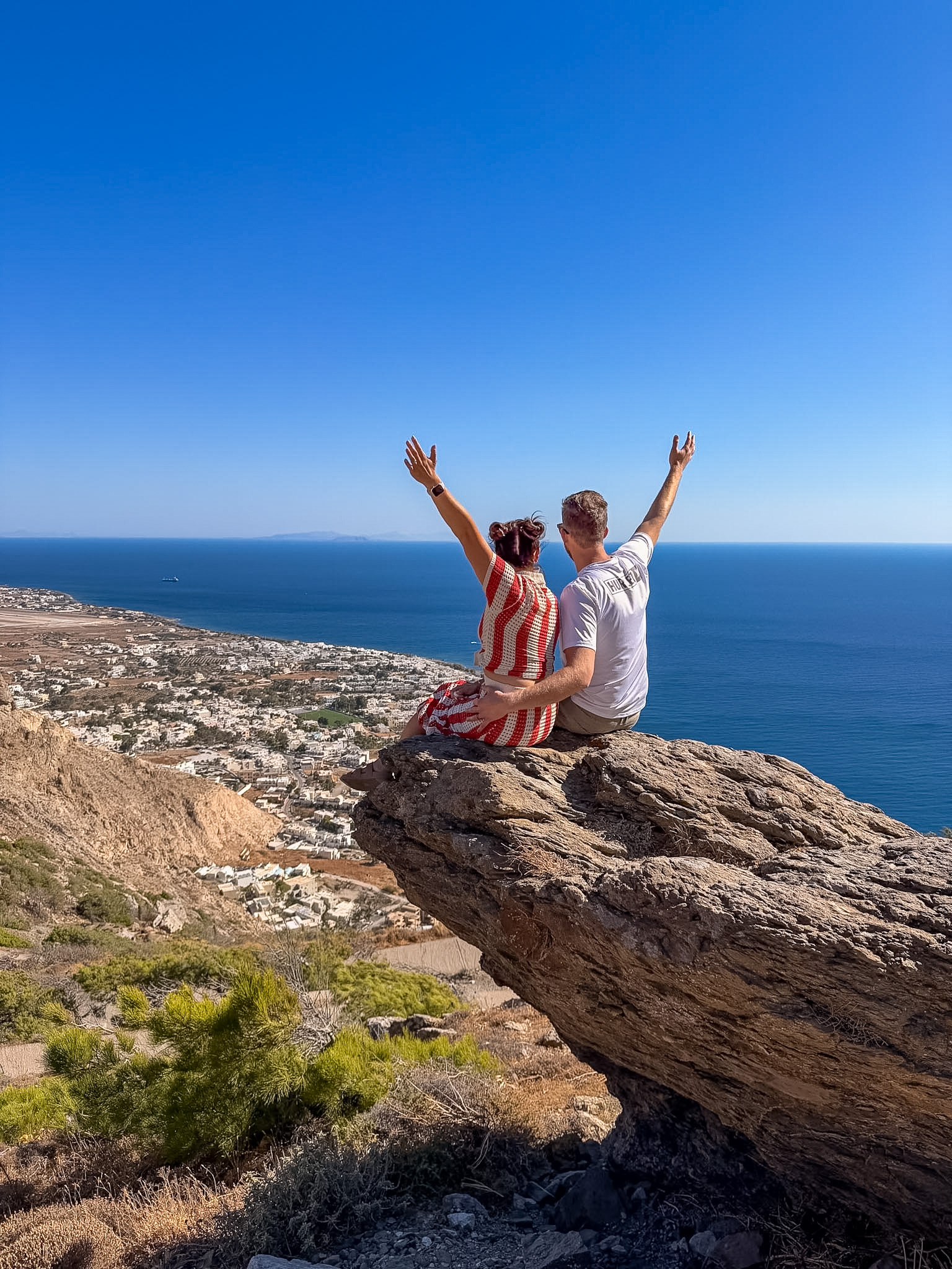 Ancient Thera ruins surrounded by rocky mountains and the blue Aegean Sea