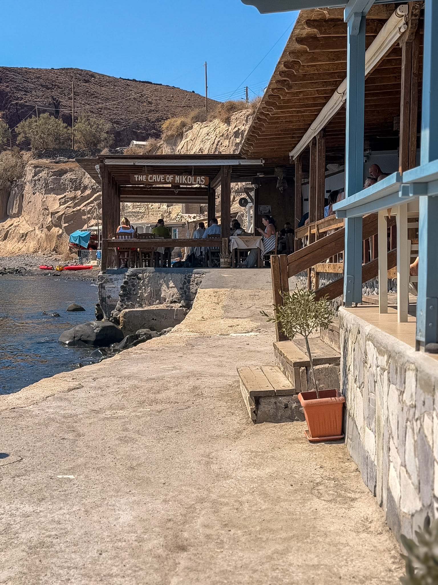 Waterfront dining tables at the Cave of Nikolas traditional Greek taverna