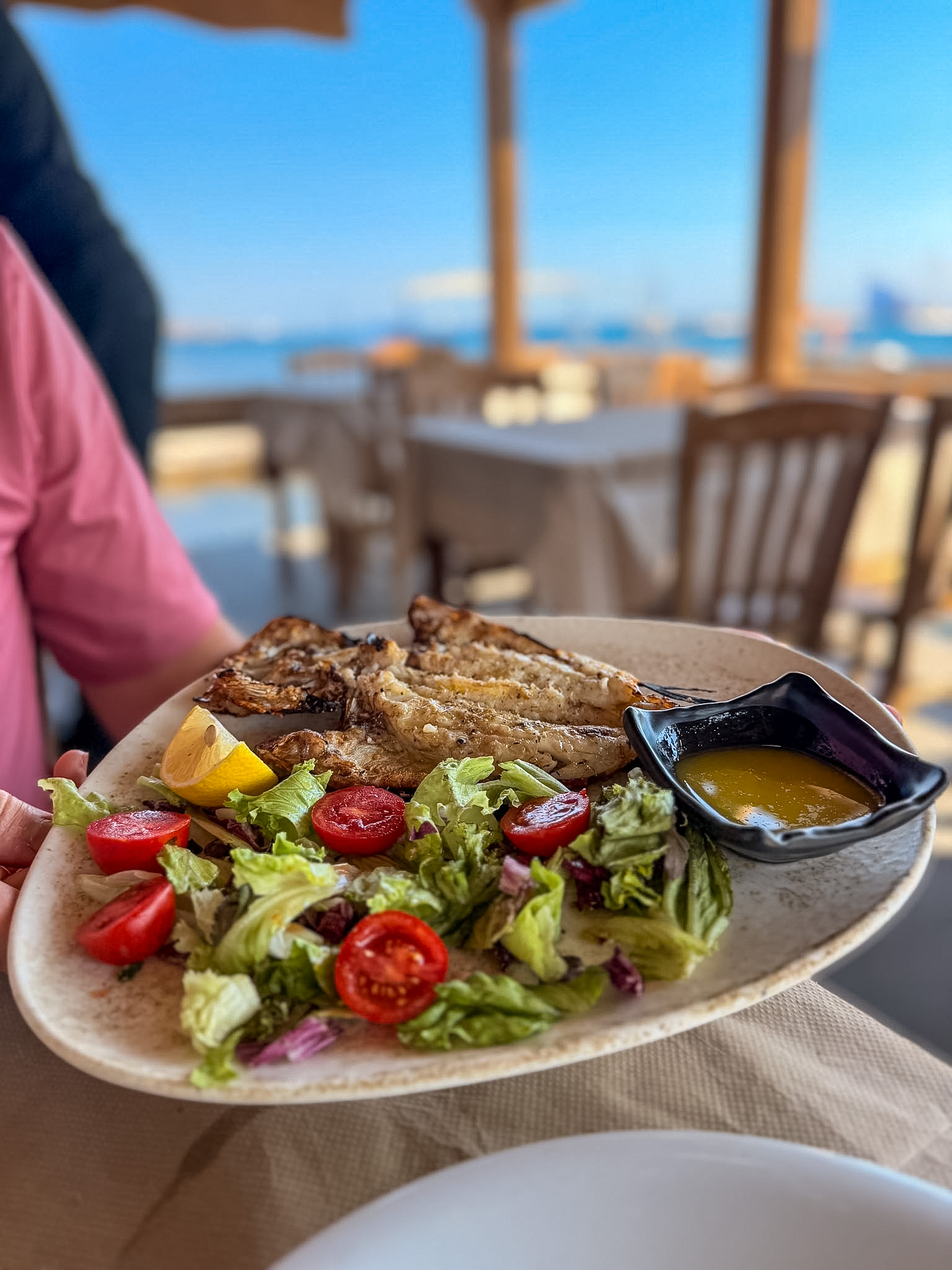 Lionfish fillet with Santorini tomatoes, capers, and grilled vegetables