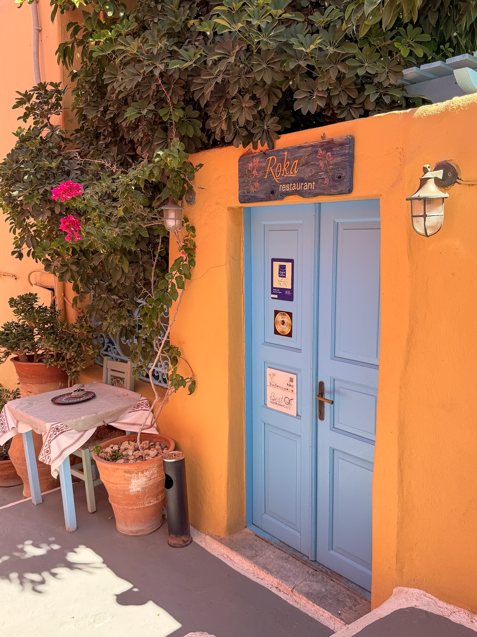 Roka Santorini restaurant exterior along a quiet alley in Oia Greece