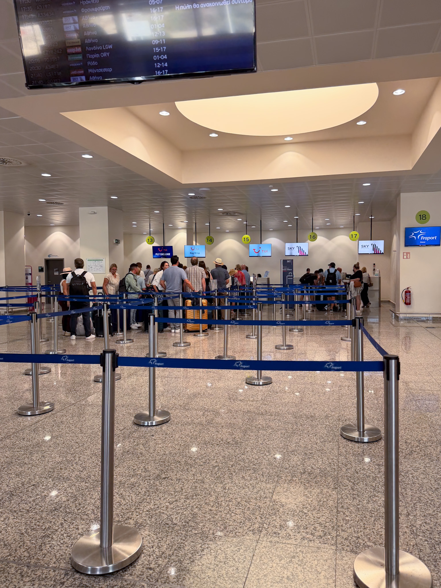 Airline check-in counters inside Santorini Airport departures